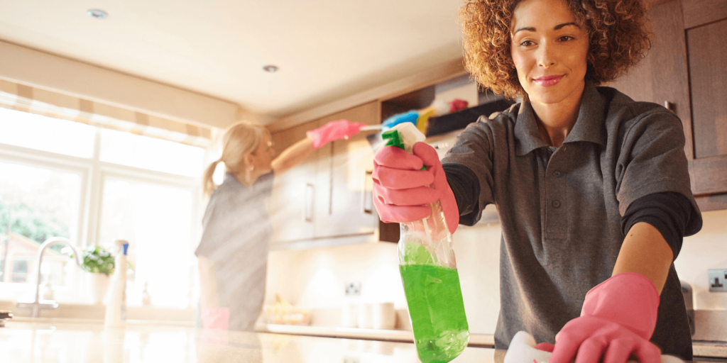 Professional cleaner using industrial floor-cleaning equipment in home.