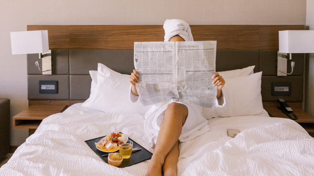 Woman reading the newspaper in bed
